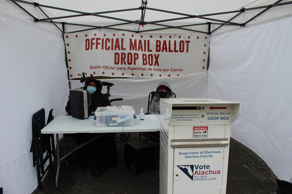 <p>Judi Jackson, a 62-year-old election volunteer (left), sits outside Alachua County Supervisor of Elections Office Jan. 22 with her fellow volunteer, checking early voting ballots. The special run-off election for City Commission At-large Seat B will be held Jan. 25. <br/></p>