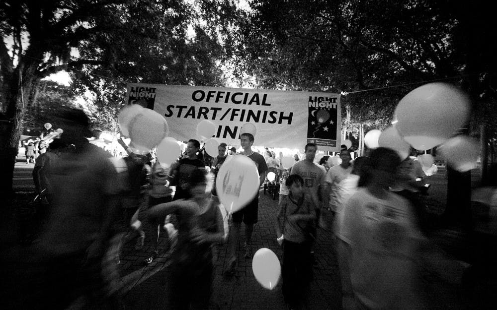 Light the Night walkers gather Thursday outside Ben Hill Griffin Stadium for a two-mile trek, which benefited cancer patients and their families. They displayed red balloons to support cancer patients and white balloons for survivors.