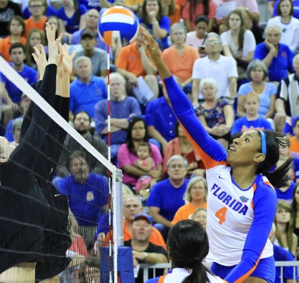 <p>Senior Tangerine Wiggs spikes the ball over the net during a match against Missouri on Friday at Stephen C. O'Connell Center. The Gators defeated the Tigers 3-0.</p>
