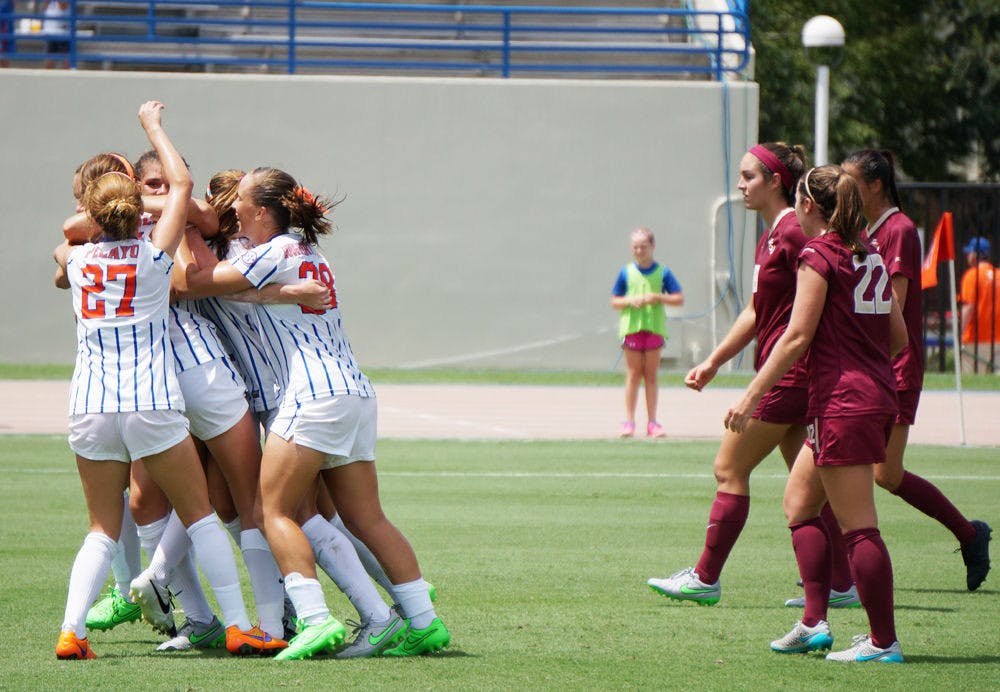 <p>UF soccer players celebrate Sarah Troccoli's goal while FSU players watch on during Florida's 3-2 win on Aug. 30, 2015, at James G. Pressly Stadium.</p>