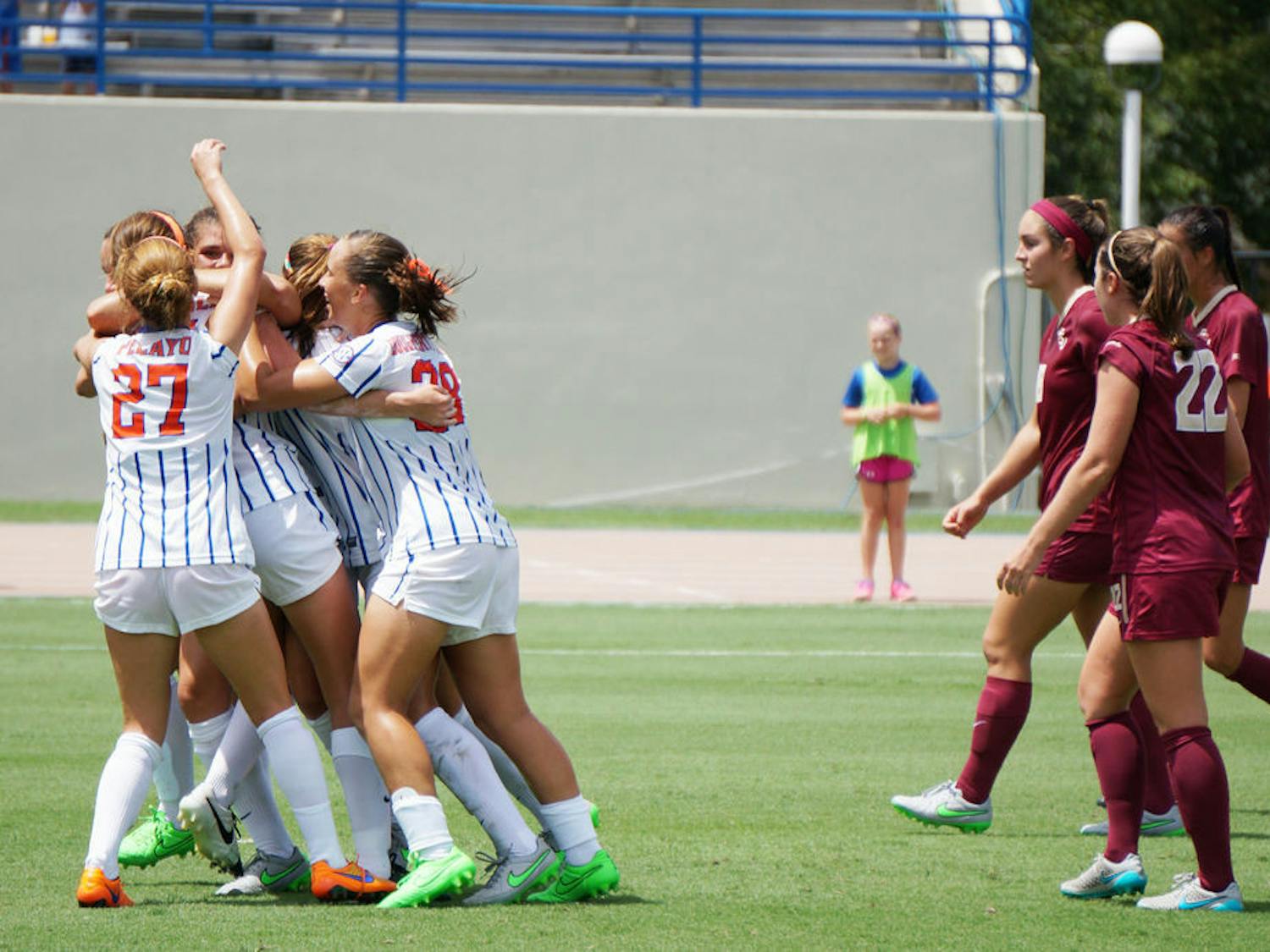 UF soccer players celebrate Sarah Troccoli's goal while FSU players watch on during Florida's 3-2 win on Aug. 30, 2015, at James G. Pressly Stadium.