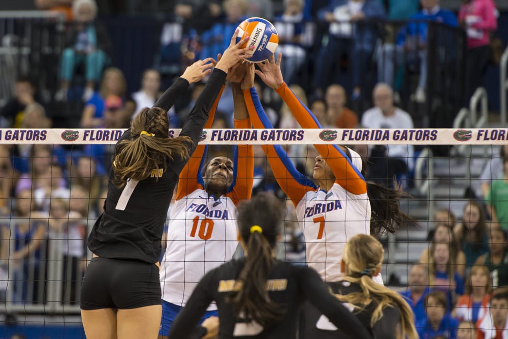 <p>Chloe Mann and Gabby Mallette try to fend off match point against Missouri's Molly Kreklow during the Gators' 3-0 loss to the Tigers on Friday night in the O'Connell Center.</p>