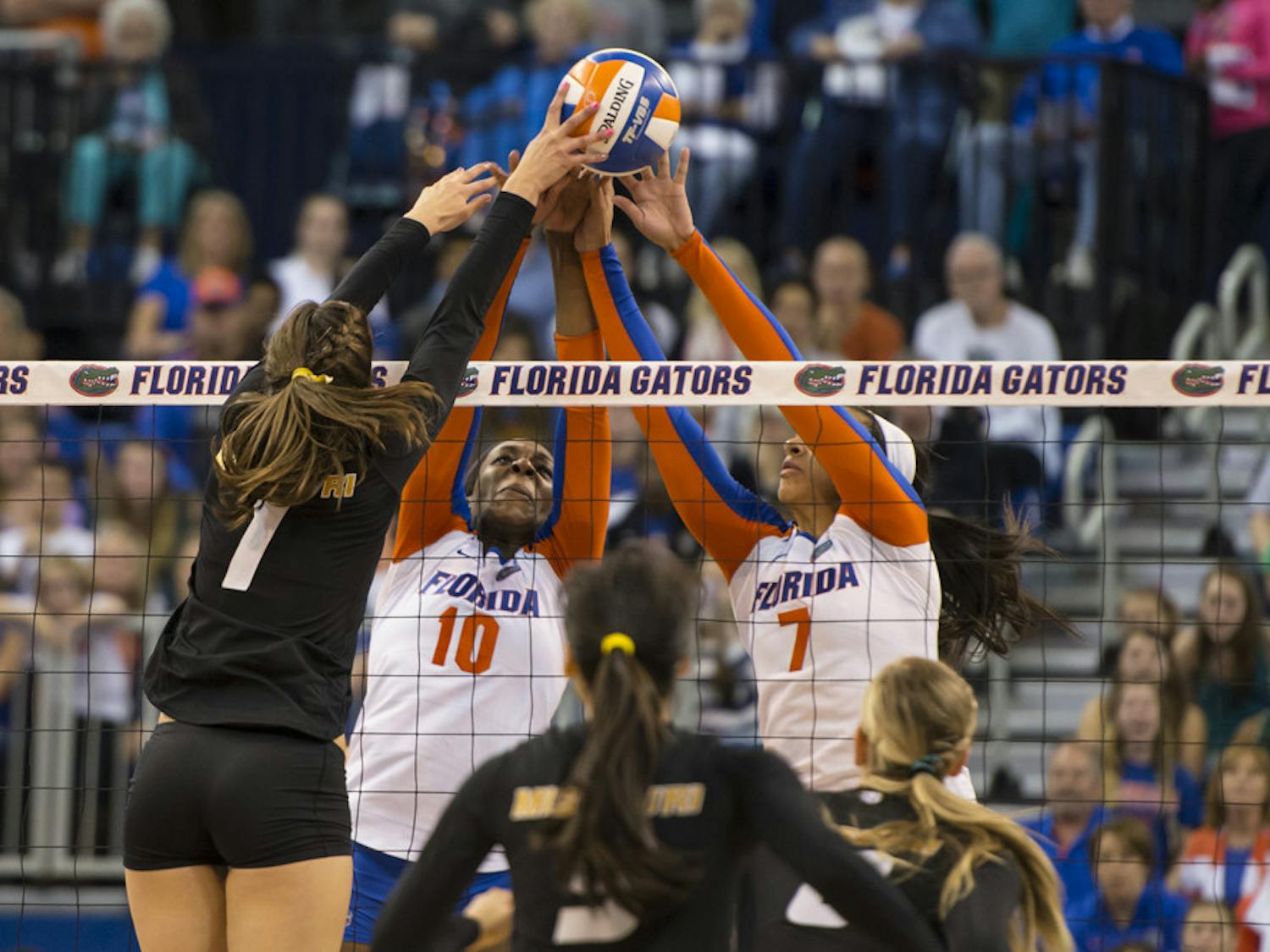 Chloe Mann and Gabby Mallette try to fend off match point against Missouri's Molly Kreklow during the Gators' 3-0 loss to the Tigers on Friday night in the O'Connell Center.