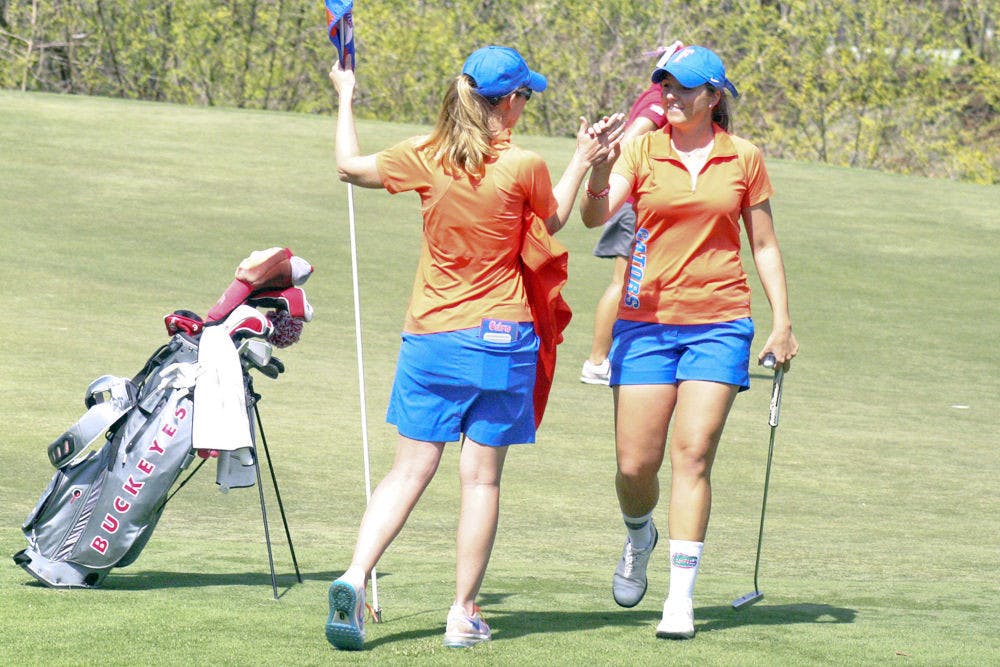 <p>Sophomore Karolina Vlckova high fives coach Emily Glaser during the final round of the 2015 SunTrust Gator Invitational on March 8.</p>