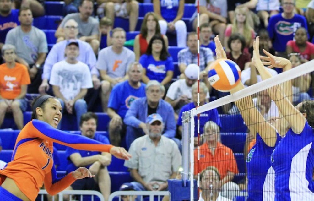 <p>Freshman Berkley Whaley (1) spike the ball over the net during Florida's match against Florida Gulf Coast at the Stephen C. O'Connell Center on Aug. 25.</p>