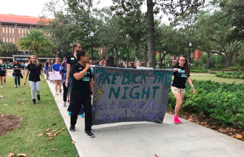 People march on Plaza of the Americas during Take Back The Night.&nbsp;