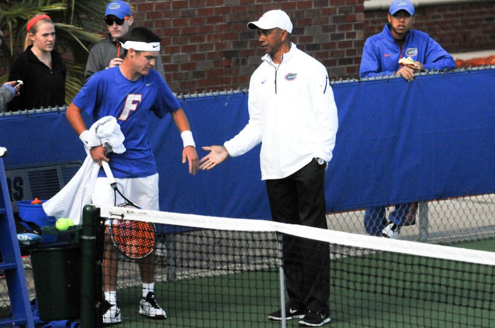 <p>UF coach Bryan Shelton (right) congratulates McClain Kessler&nbsp;during Florida's 6-1 win over Troy on Jan. 17, 2016, at the Ring Tennis Complex.</p>