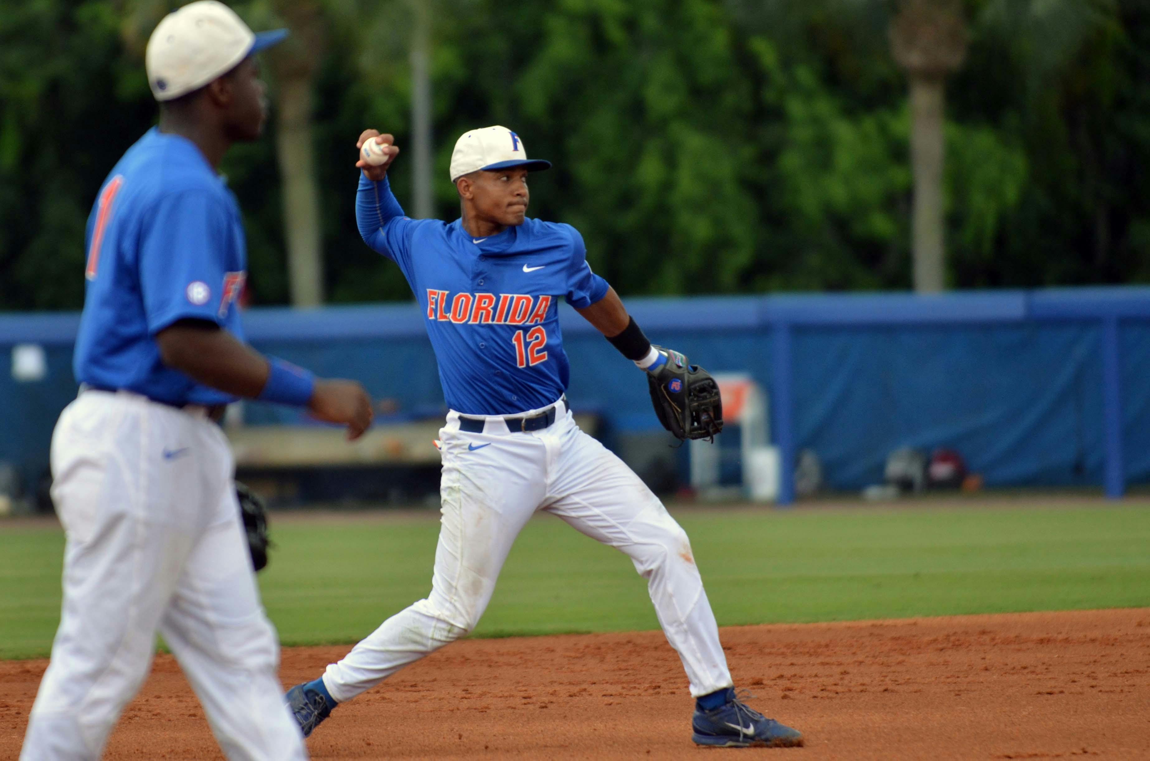 UF shortstop Richie Martin (12) throws to first base for an out during Florida's 12-5 win against South Carolina on April 11 at McKethan Stadium.