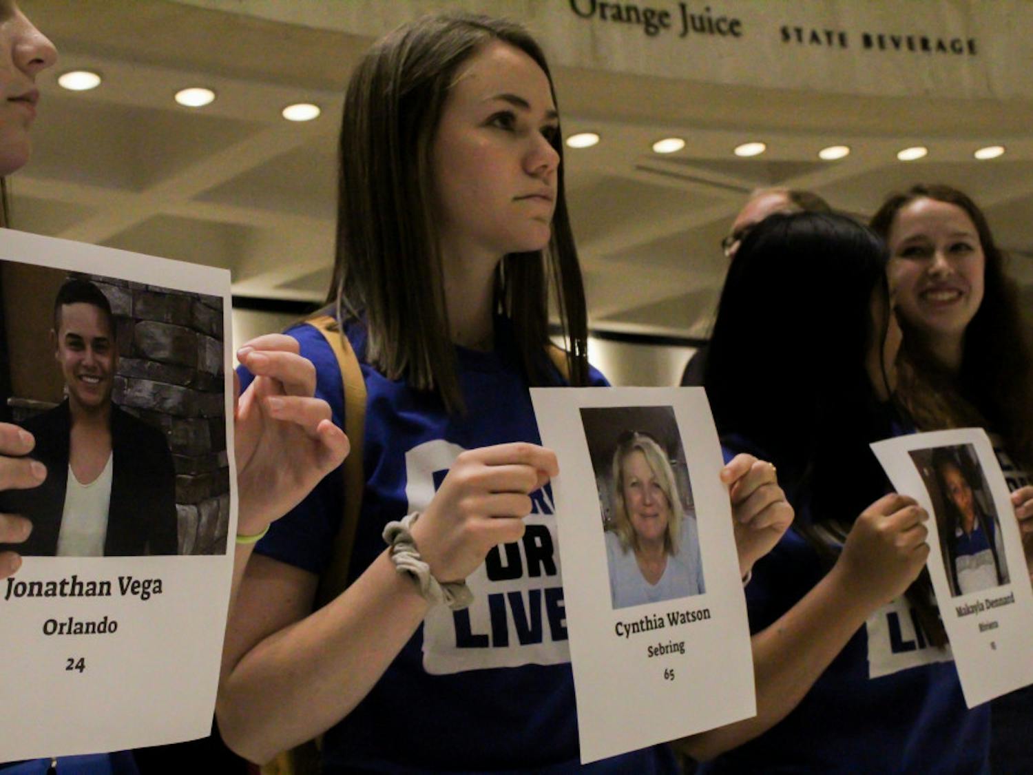 Lauren Herwitz (center), an 18-year-old UF Health Science and theater freshman and March For Our Lives Gainesville member, protests Florida Senate Bill 7030, which would allow teachers to carry firearms in case of an active shooter, Wednesday afternoon. “I’m almost in tears, this is just incredibly powerful and emotional," she said.
