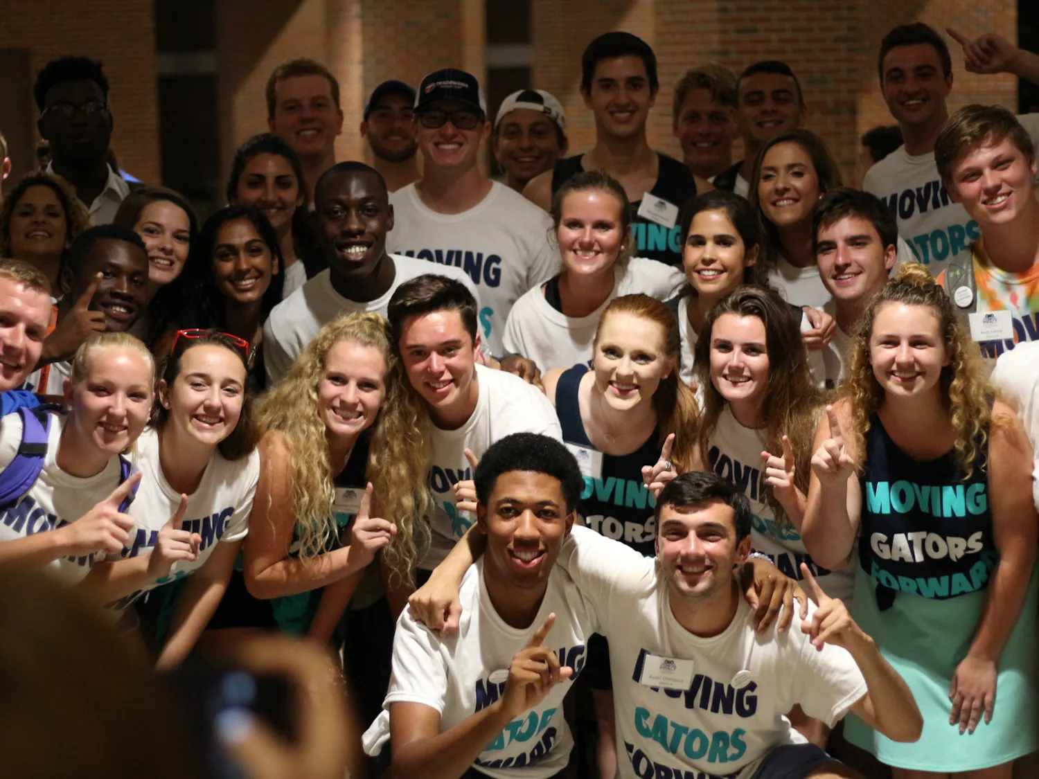 Impact Party candidates and supporters crowd the Reitz Union Breezeway on Wednesday to commemorate the election night with a picture.