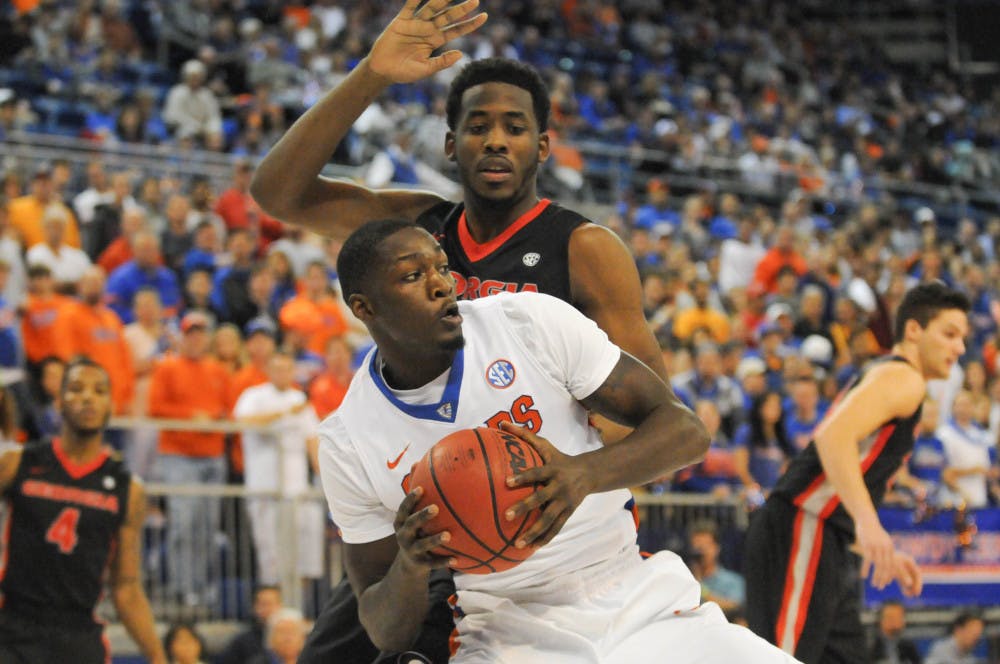 UF’s Dorian Finney-Smith looks to pass during Florida’s 77-63 win against Georgia on Jan.2, 2016, in the O’Connell Center.