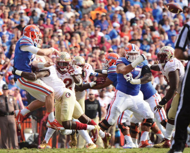 Skyler Mornhinweg is hit while he attempts to throw a pass during Florida’s 37-7 loss to No. 2 Florida State on Saturday in Ben Hill Griffin Stadium. The redshirt freshman quarterback completed 20 of 25 passes for 115 yards but could not keep the Gators from suffering their seventh consecutive loss to finish the season.