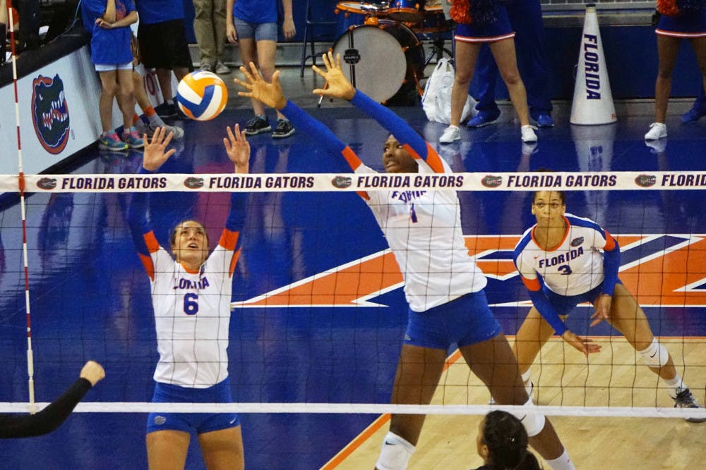 <p>UF setter Mackenzie Dagostino (6) and middle blocker Rhamat Alhassan (1) jump for a block during Florida's 3-1 win on Sept. 20, 2015, in the O'Connell Center.</p>