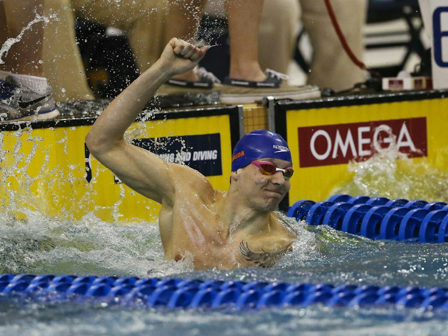 Florida's Caeleb Dressel reacts after winning the 100-yard freestyle at the NCAA men's swimming and diving championships Saturday, March 26, 2016, in Atlanta. The initials on his face are in honor of a former teacher. (AP Photo/John Bazemore)