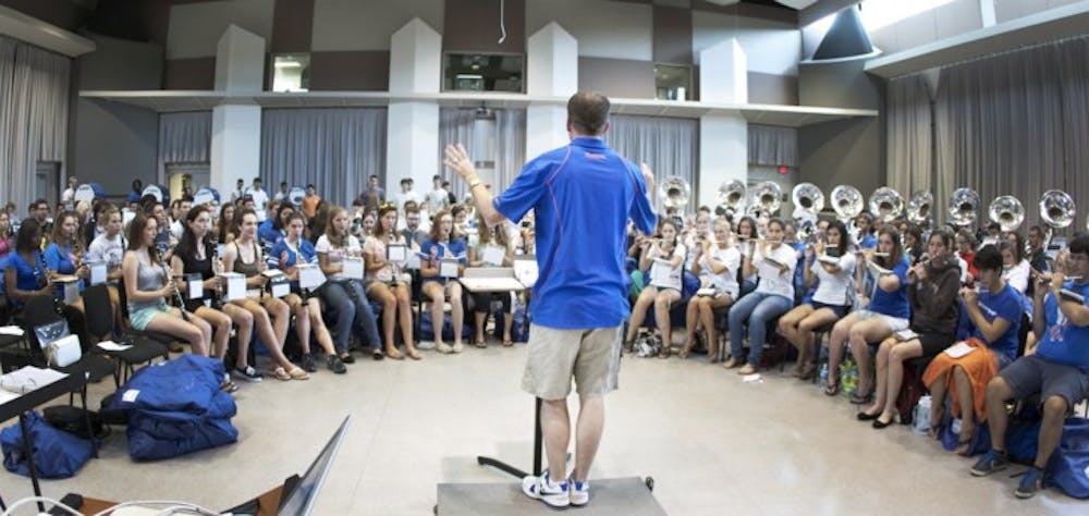 <p>Jay Watkins, UF associate director of bands, conducts a final rehearsal Sunday at the Steinbrenner Band Building before departing for London Monday. The band will perform Friday before the opening ceremony of the 2012 Summer Olympics.</p>