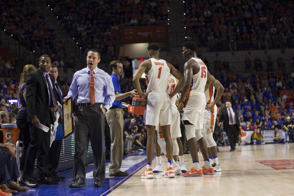 Florida forward Devin Robinson (left) and center John Egbunu stand in a timeout huddle during Florida's 71-62 win over Texas A&amp;M on Feb. 11 in the O'Connell Center. 