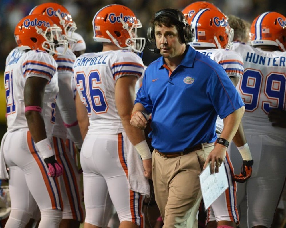 <p>Coach Will Muschamp walks toward the sideline after a timeout against Vanderbilt on Saturday. Florida erased a first quarter deficit en route to a 16-point victory.</p>
