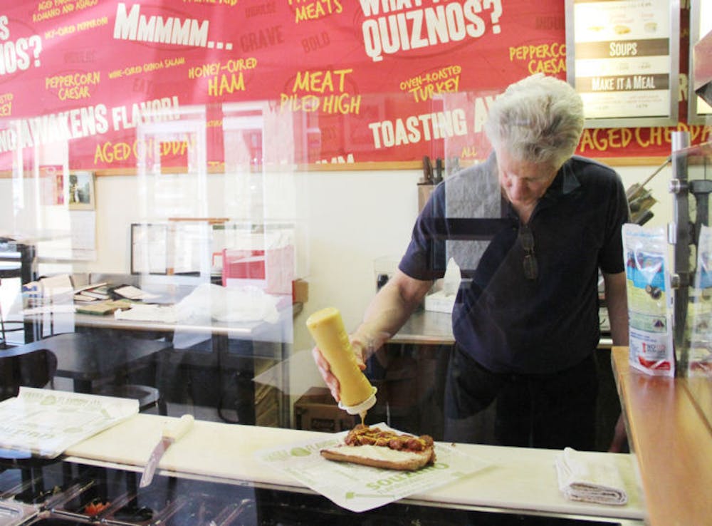 <p class="p1">Lance O’Carroll, the owner of Gainesville’s last Quiznos, makes a sandwich for a customer. Located at 3545 SW 34th St., the store will be making its last sub Saturday after being open for 10 years.</p>