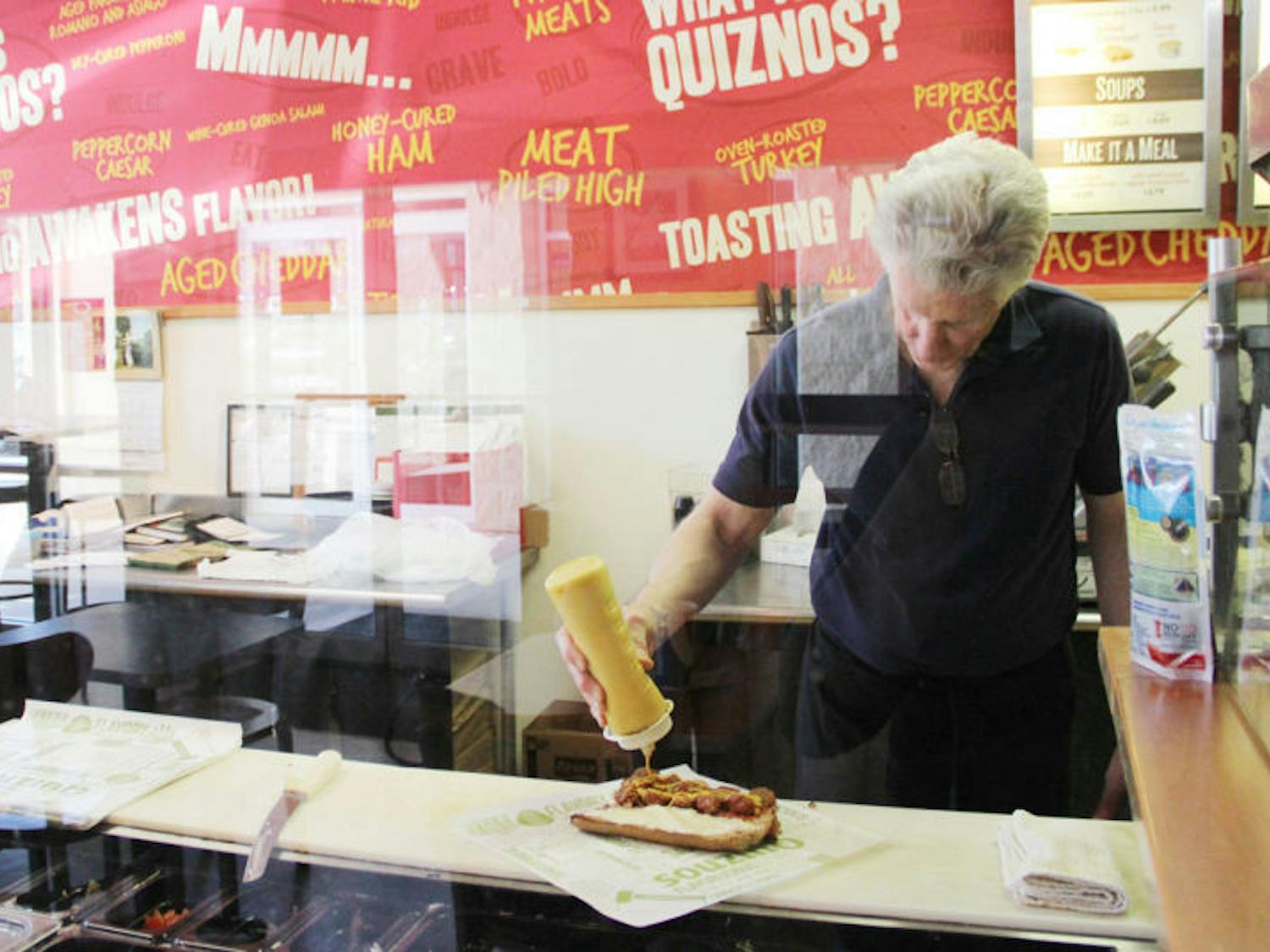 Lance O’Carroll, the owner of Gainesville’s last Quiznos, makes a sandwich for a customer. Located at 3545 SW 34th St., the store will be making its last sub Saturday after being open for 10 years.