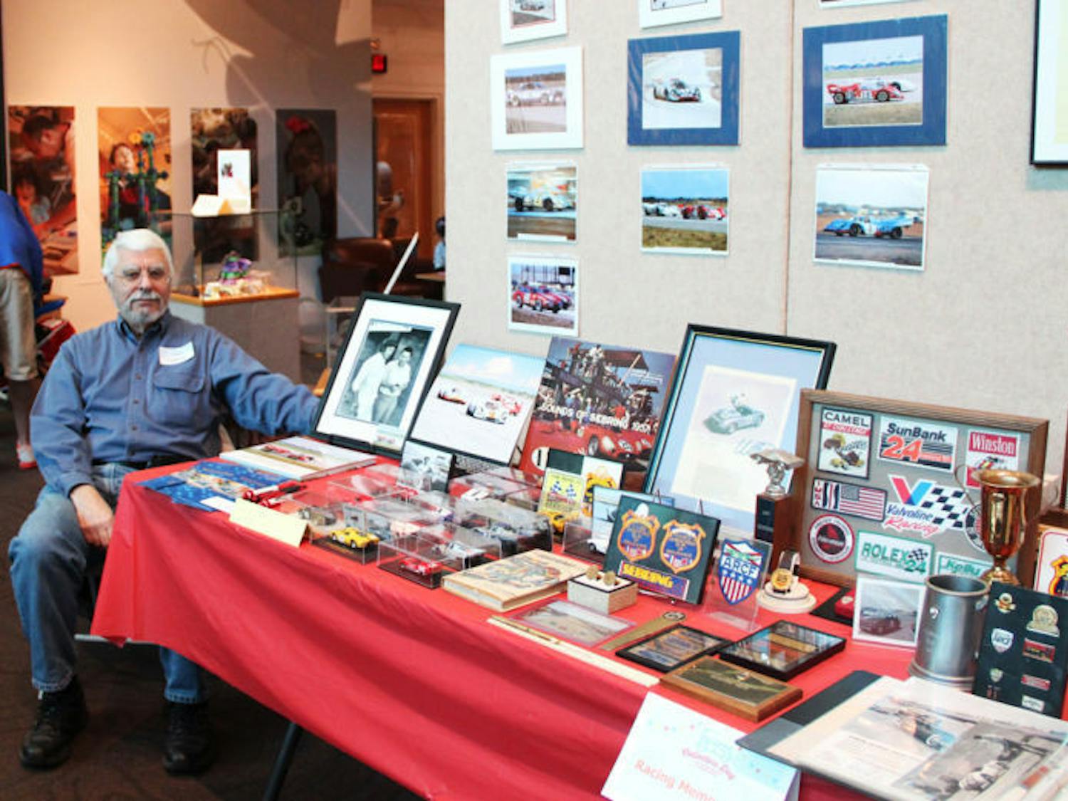 Louis Galanos, a 68-year-old Gainesville resident, displays his collection of racing memorabilia on Saturday at the 35th annual Collectors Day at the Florida Museum of Natural History.