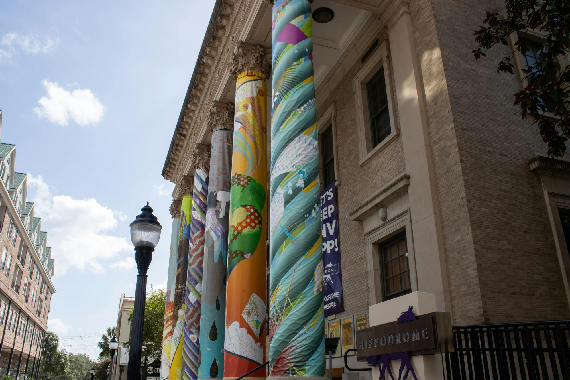 Art exhibit "a river full of all my lost loved ones" displayed on the columns of the Hippodrome Theatre, Wednesday, Sept. 16, 2026, in Gainesville, Fla.