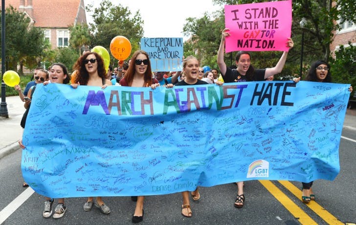 Students march down Buckman drive during the March Against Hate on Thrusday afternoon. Several UF student organizations joined together to hold the demonstration.