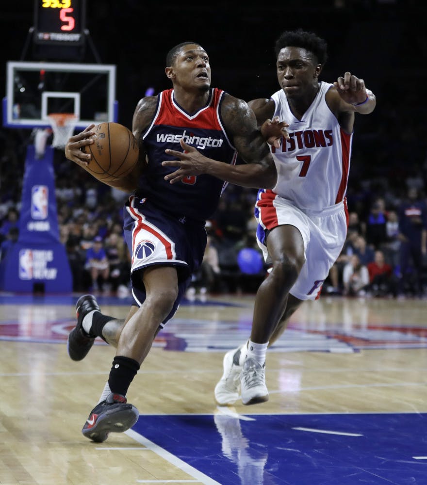 Washington Wizards guard Bradley Beal (3) drives on Detroit Pistons forward Stanley Johnson (7) during second half of an NBA basketball game, Monday, April 10, 2017, in Auburn Hills, Mich. (AP Photo/Carlos Osorio)