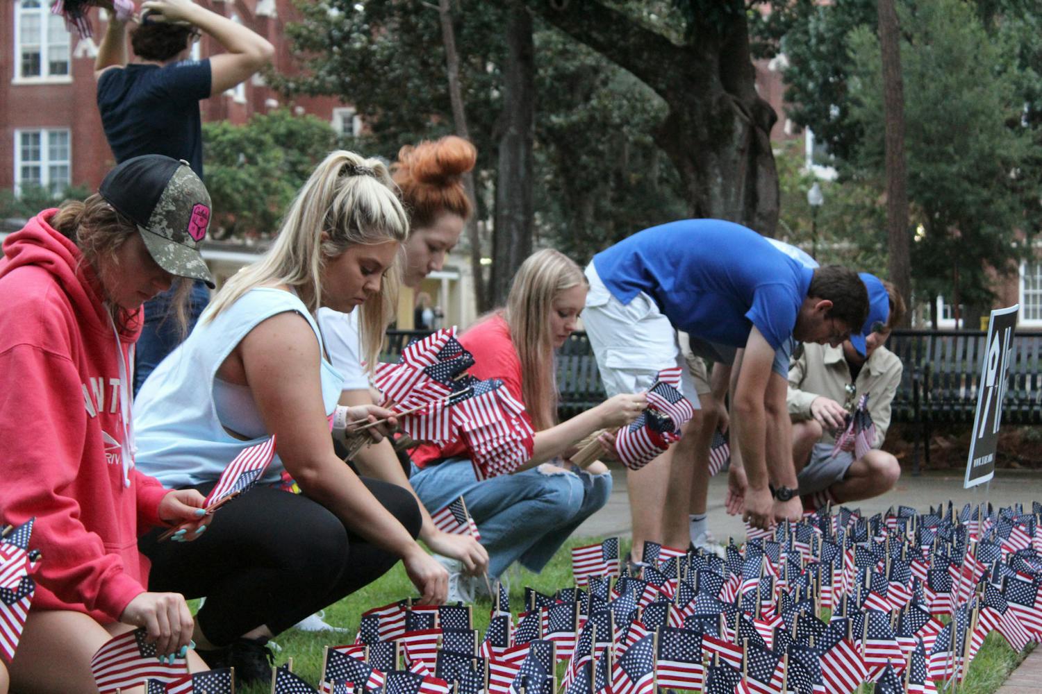 On Saturday, Sept. 11, 2021, city residents and university members across Gainesville commemorated what happened on 9/11, 20 years ago. UF Young Americans for Freedom planted 2,977 flags in the ground to represent the lives lost. About 50 people gathered at Reserve Park to share stories about how 9/11 impacted them. Collegiate Veterans Society members, firefighters and friends met at Ben Hill Griffin Stadium to climb the steps to honor those who climbed the tower stairs and saved thousands of lives.&nbsp;