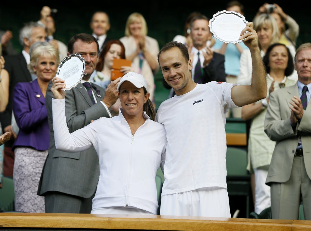 <p>Bruno Soares of Brazil, right, and Lisa Raymond of the United States pose with the trophy for runner up after losing to Daniel Nestor of Canada and Kristina Mladenovic of France after the mixed doubles final match at the All England Lawn Tennis Championships in Wimbledon, London, on Sunday.</p>