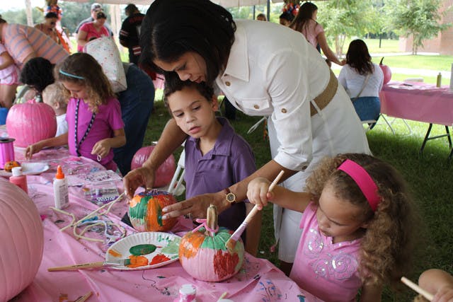 Holly Knapick paints pumpkins Saturday at the Cancer Genetics Research Complex with her son Jack, 5, and daughter Angie, 3. She lost two aunts to the disease and thought the party would be fun.