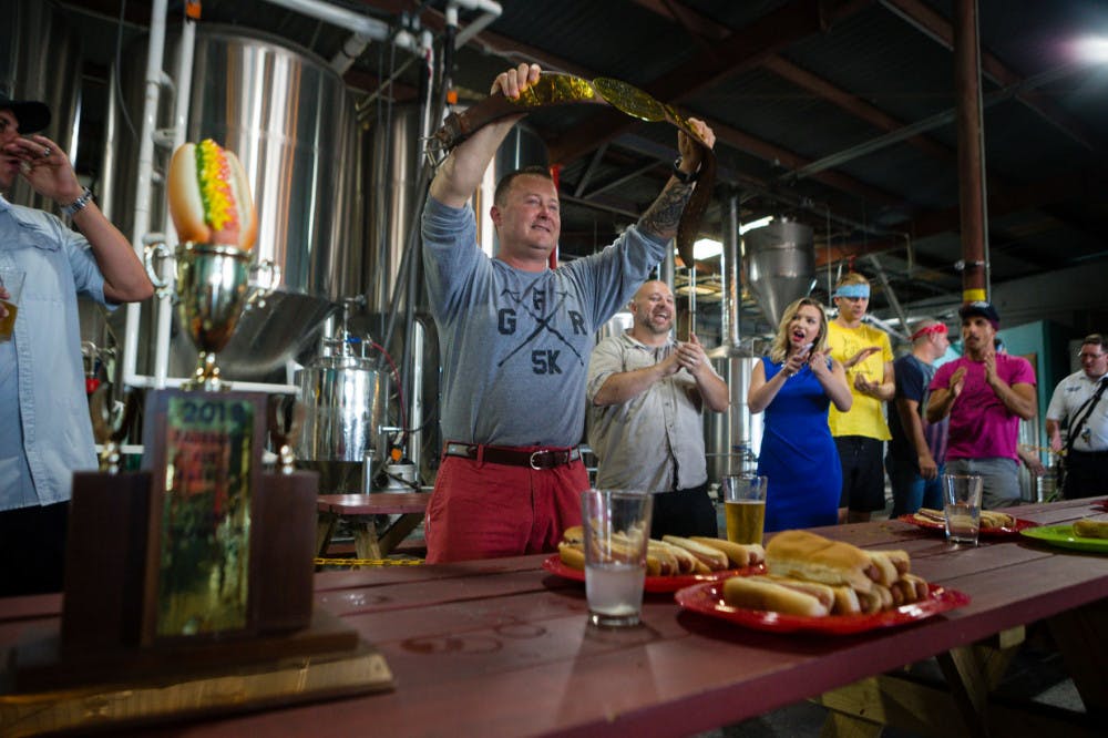 Lt. Sean Withers from Gainesville Fire Rescue won the grand champion belt for eating the most hot dogs (eight) by himself. Withers and other members of GFR were awarded first prize during the competition. Together, they consumed 25 hot dogs.&nbsp;&nbsp;