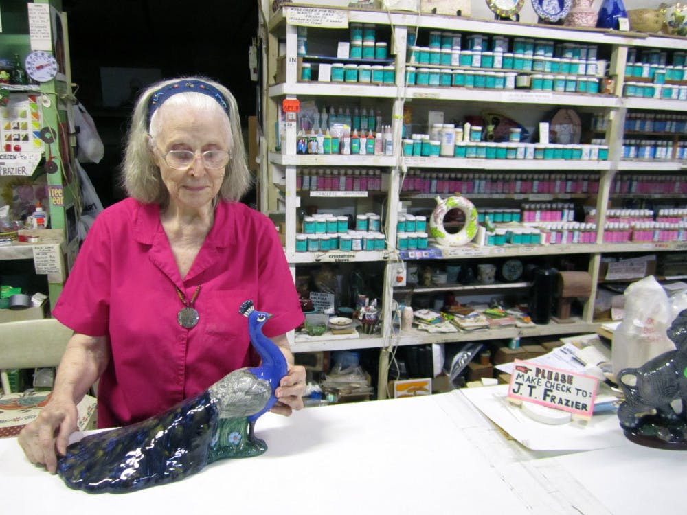 Juanita Frazier, 85, shows a ceramic peacock she repaired and painted herself. She has owned Frazier Ceramic Shop, 8601 SW Williston Road, since 1971 after moving back to Alachua County. 