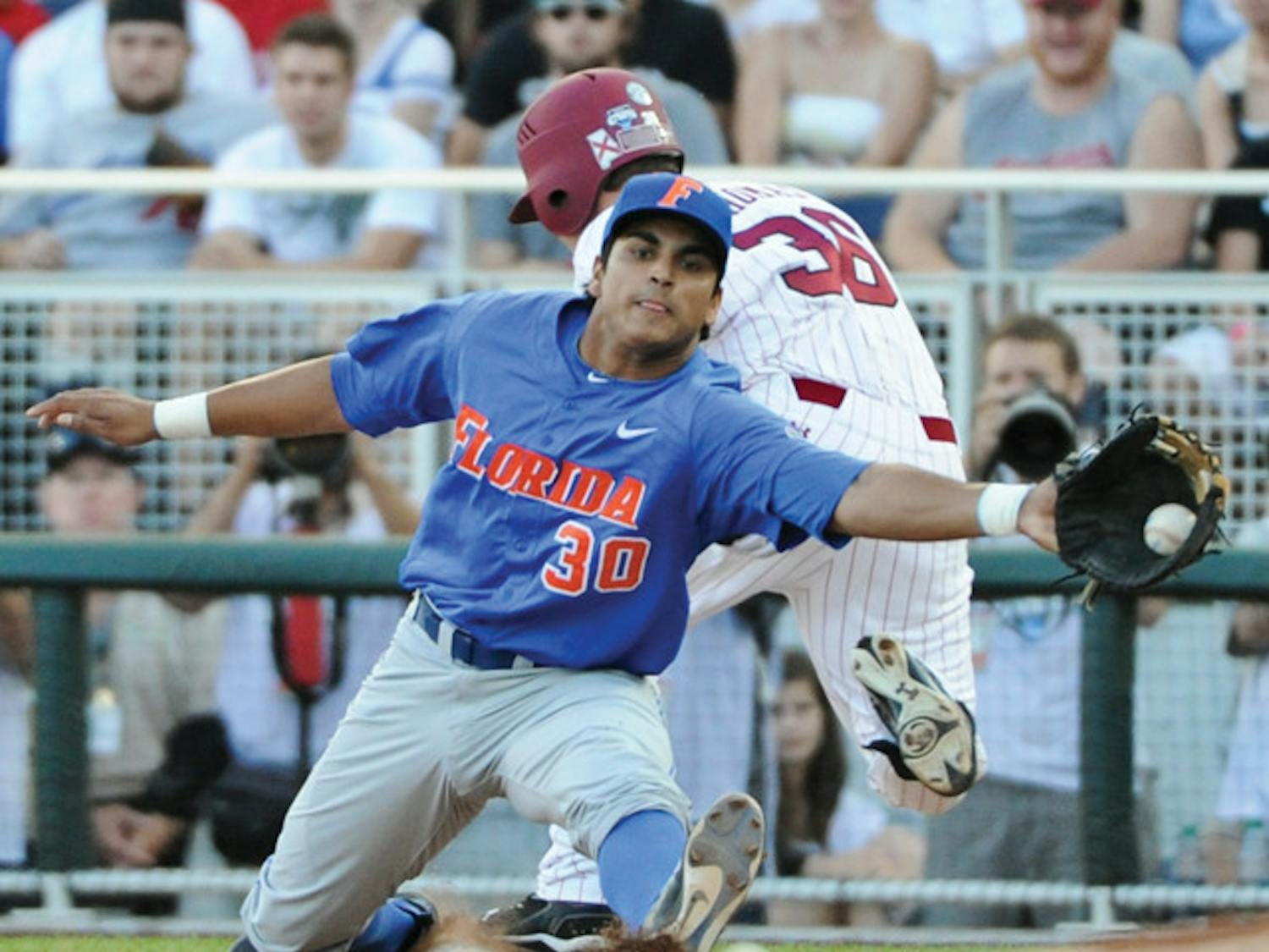 South Carolina's Brady Thomas (36) is safe at first base against Florida first baseman Vickash Ramjit (30) on an RBI-single in the third inning of Game 2 of the NCAA baseball College World Series best-of-three finals, in Omaha, Neb., Tuesday, June 28, 2011. (AP Photo/Eric Francis)