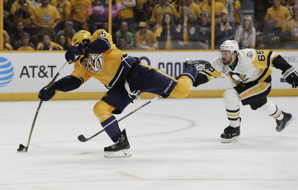 <p>Nashville Predators right wing Craig Smith (left) shoots during the third period of game three in the Stanley Cup Finals on Saturday in Nashville, Tennessee.</p>