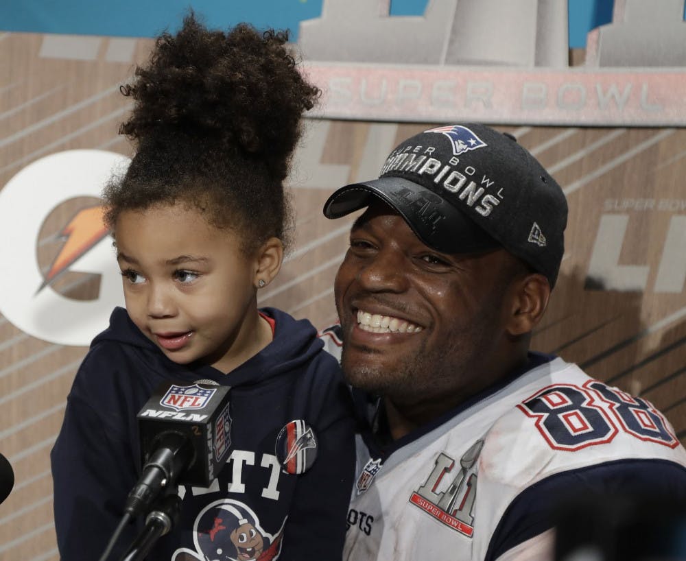 New England Patriots' Martellus Bennett appears at a news conference with his daughter Austyn Jett Rose Bennett after the NFL Super Bowl 51 football game Sunday, Feb. 5, 2017, in Houston. The New England Patriots won 34-28 in overtime. (AP Photo/Chuck Burton)