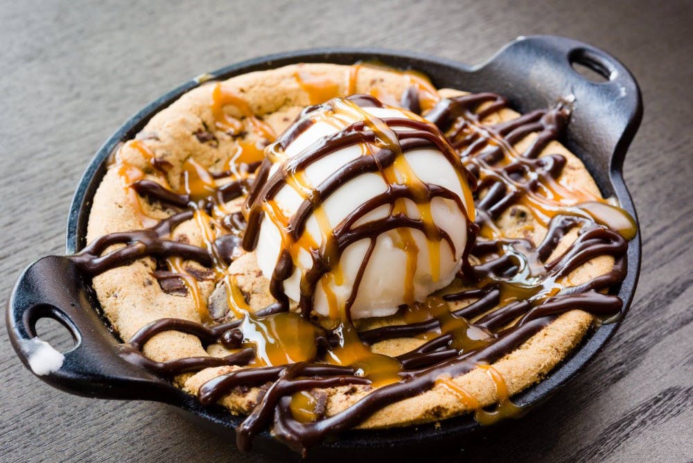A chocolate chip cookie skillet topped with gelato, chocolate and caramel sauce. 