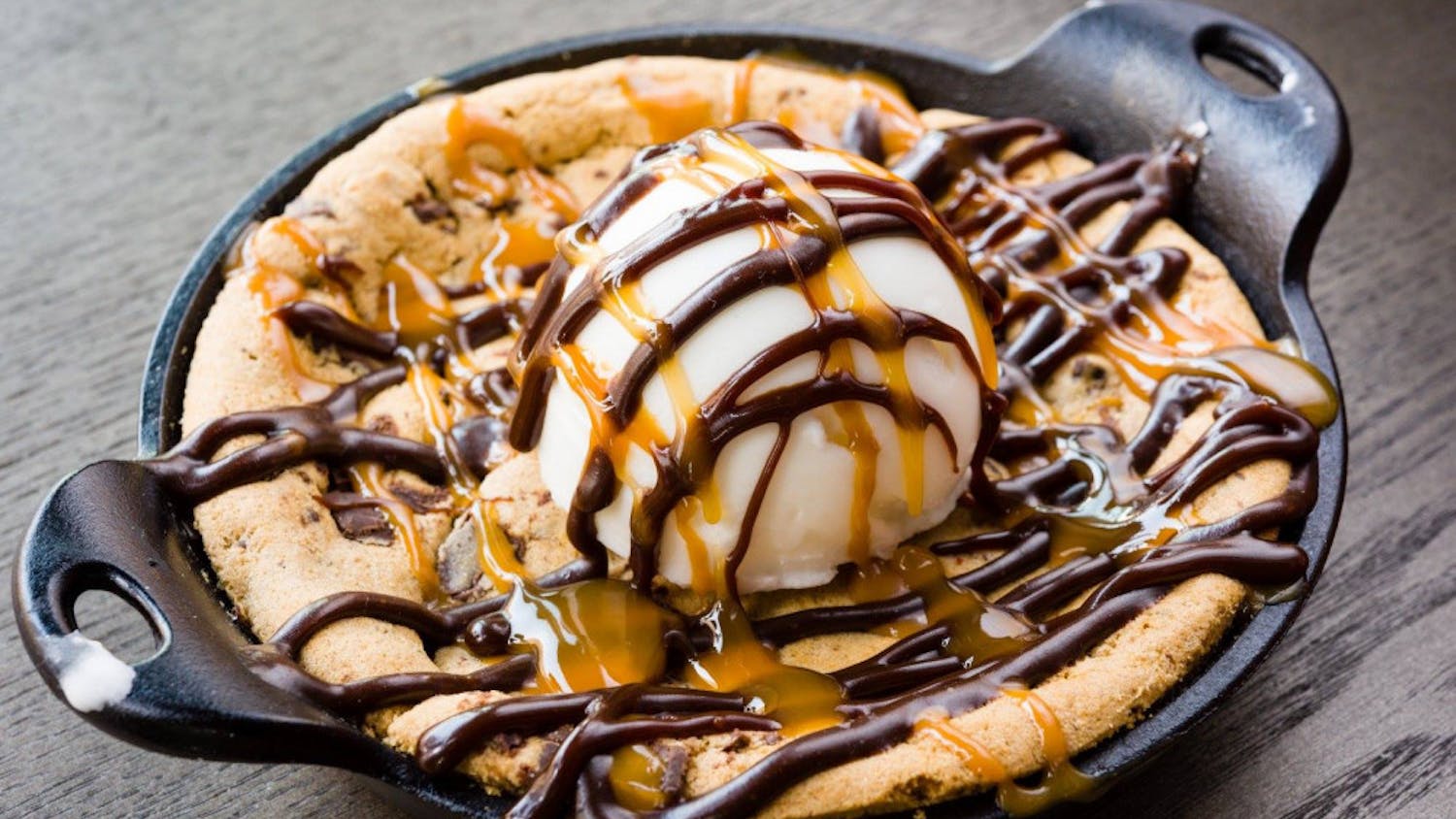 A chocolate chip cookie skillet topped with gelato, chocolate and caramel sauce. 