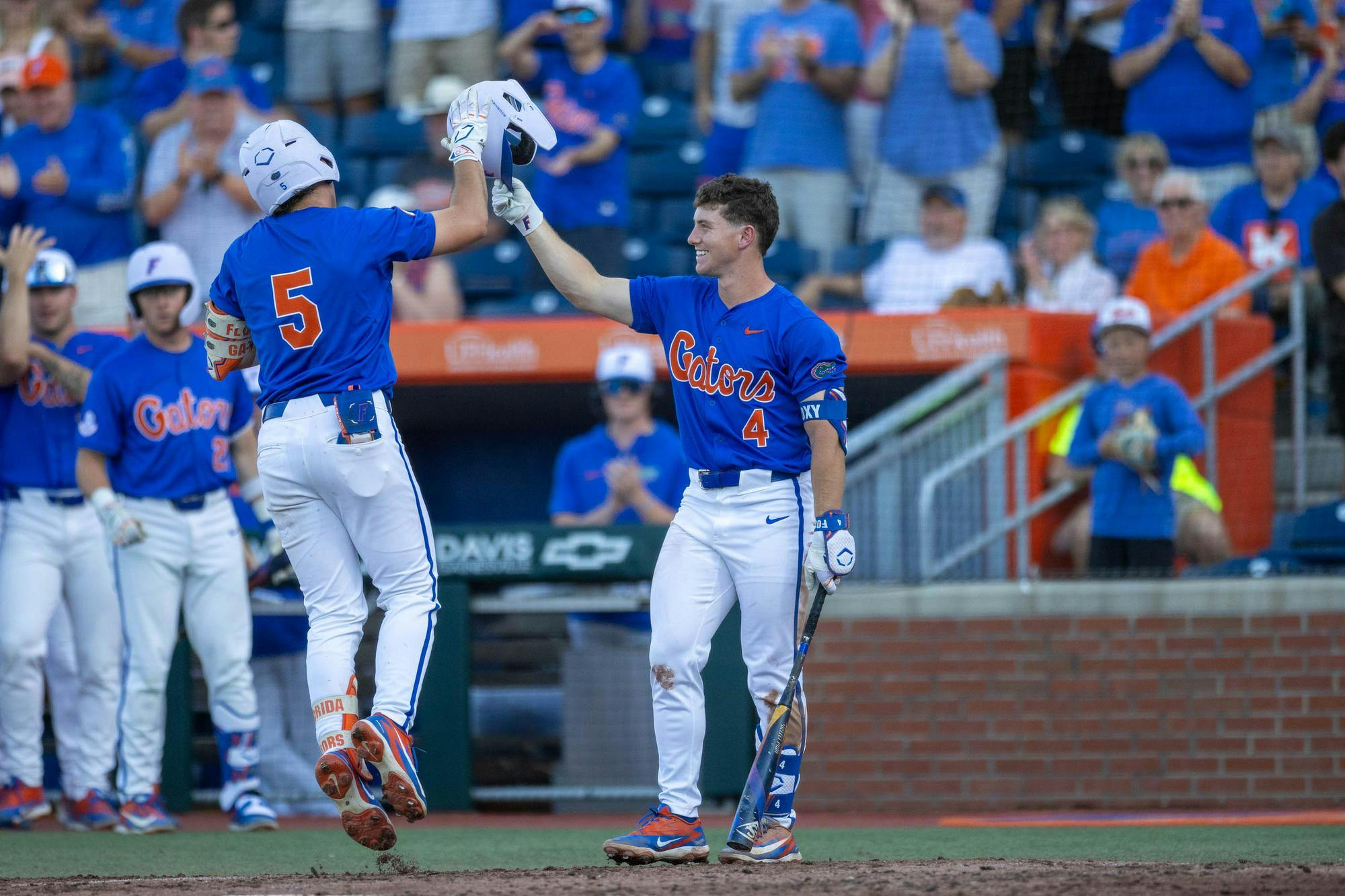 Florida infielder Cade Kurland (4) and infielder Blake Cyr (5) high-five after a home run during an NCAA college baseball game against Auburn at Condron Family Ballpark in Gainesville, Fla., Friday, April 17, 2026.