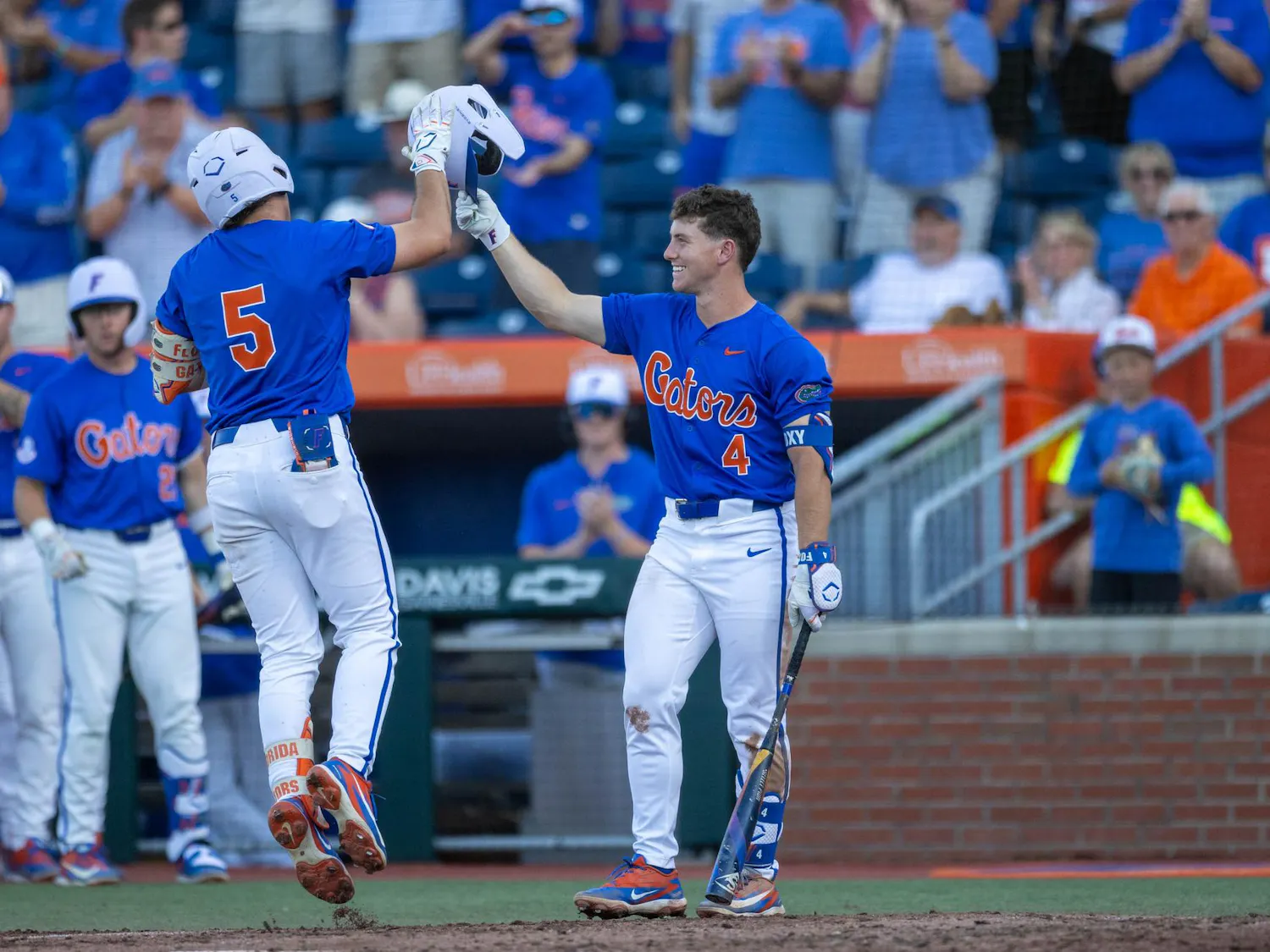 Florida infielder Cade Kurland (4) and infielder Blake Cyr (5) high-five after a home run during an NCAA college baseball game against Auburn at Condron Family Ballpark in Gainesville, Fla., Friday, April 17, 2026.