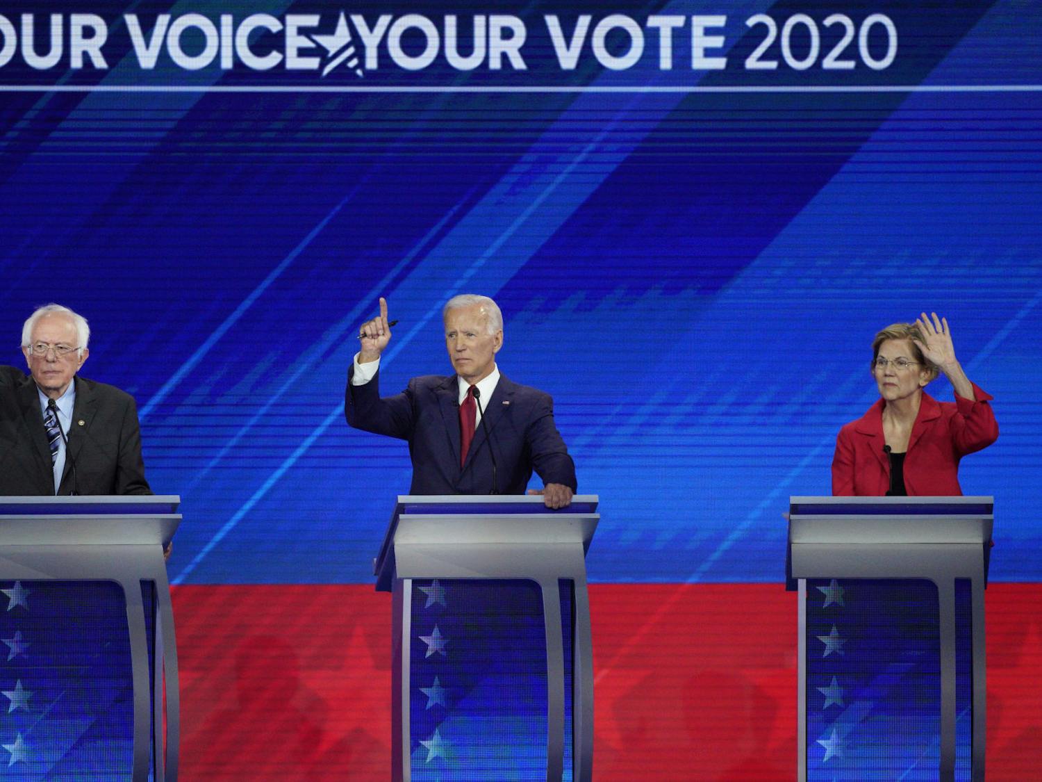 From left, Democratic presidential candidates Sen. Bernie Sanders, I-Vt., former Vice President Joe Biden and Sen. Elizabeth Warren, D-Mass. raise their hands to answer a question Thursday, Sept. 12, 2019, during a Democratic presidential primary debate hosted by ABC at Texas Southern University in Houston. (AP Photo/David J. Phillip)