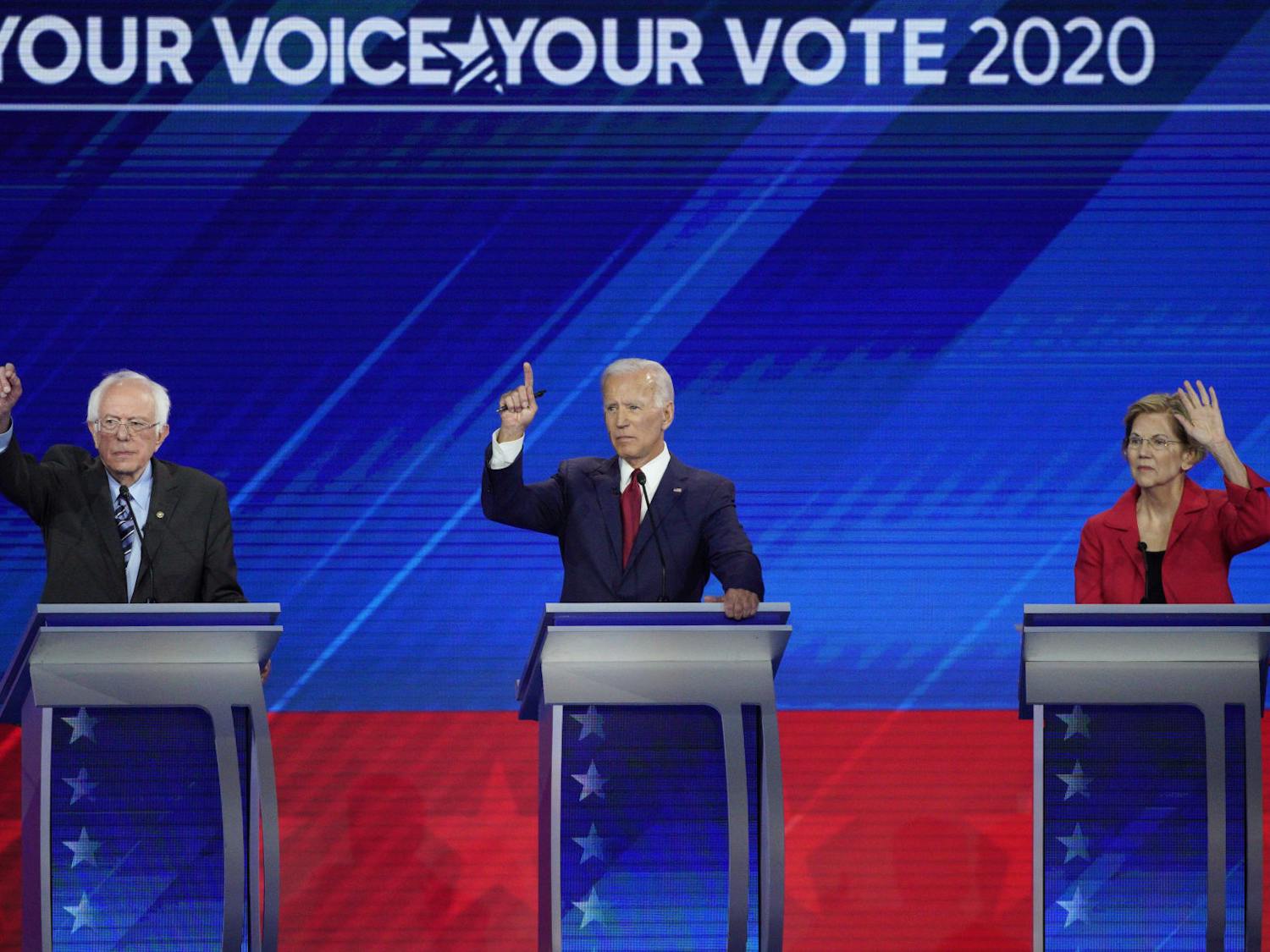 From left, Democratic presidential candidates Sen. Bernie Sanders, I-Vt., former Vice President Joe Biden and Sen. Elizabeth Warren, D-Mass. raise their hands to answer a question Thursday, Sept. 12, 2019, during a Democratic presidential primary debate hosted by ABC at Texas Southern University in Houston. (AP Photo/David J. Phillip)