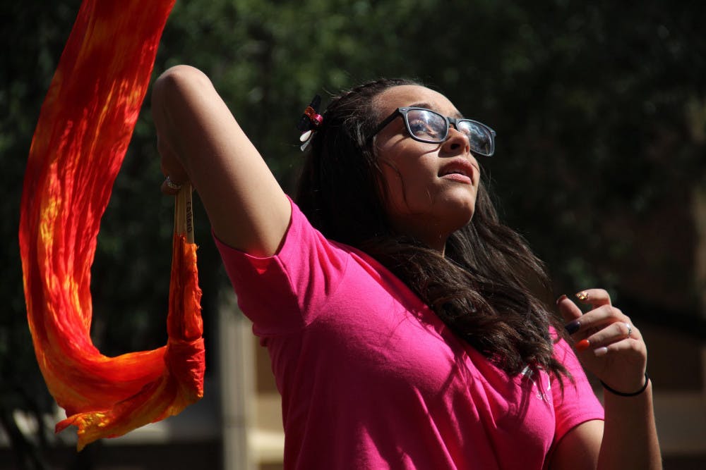 Carla Collazo, a 16-year-old from Puerto Rico, leads her veiled-fan dance group for Iglesia Casa Del Alfarero, or Potter's House Church, during the Downtown Latino Festival in Bo Diddley Plaza Saturday afternoon. 