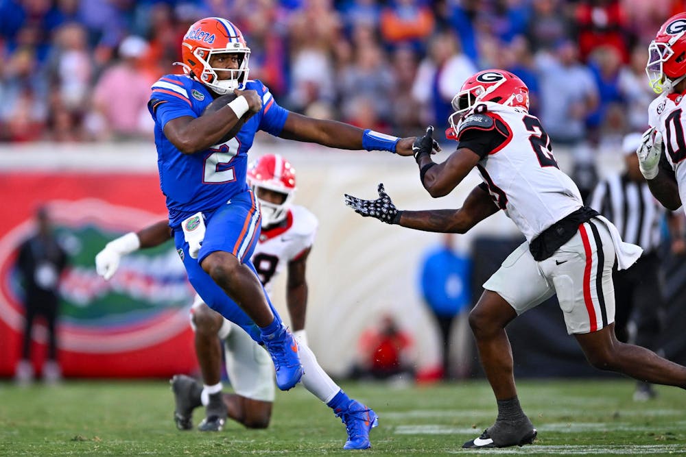 Florida quarterback DJ Lagway (2) throws a stiff arm during a NCAA college football game, Saturday, Nov. 1, 2025, in Jacksonville, Fla.