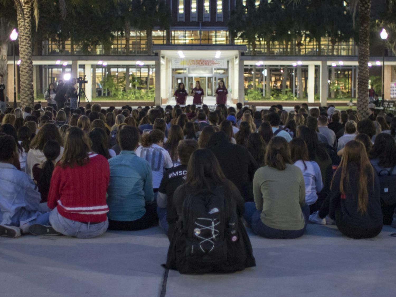 More than 200 people listen to six speakers Thursday on Plaza of the Americas during the vigil for the one-year anniversary of the Marjory Stoneman Douglas shooting.
