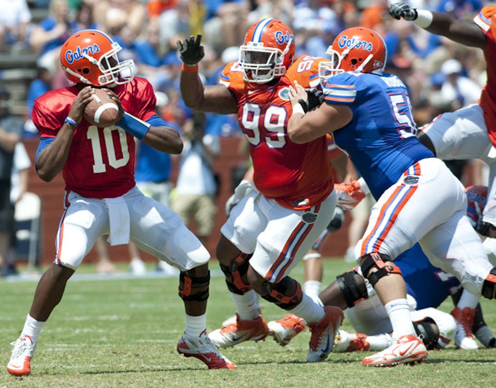 <p>Quarterback Tyler Murphy gets ready to throw a pass during Florida's annual Orange and Blue Game in 2011. With Jeff Driskel (appendectomy) out, Murphy practiced with the first-team offense during Day 1 of fall camp on Friday.&nbsp;</p>