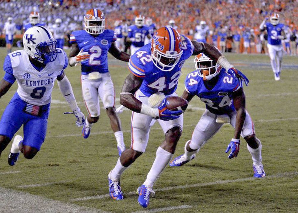 <p>Florida safety Keanu Neal intercepts a pass during the Gators' 36-30 triple-overtime win against Kentucky on Sept. 14, 2015, at Ben Hill Griffin Stadium.</p>