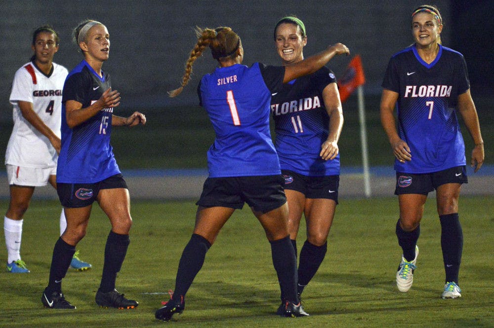 Brooke Sharp (11) celebrates with teammates following her goal during Florida's 2-1 win against Georgia on Friday at James G. Pressly Stadium.