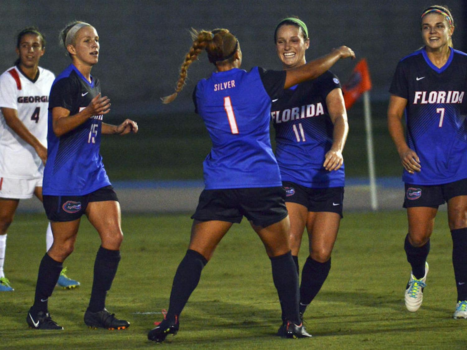 Brooke Sharp (11) celebrates with teammates following her goal during Florida's 2-1 win against Georgia on Friday at James G. Pressly Stadium.
