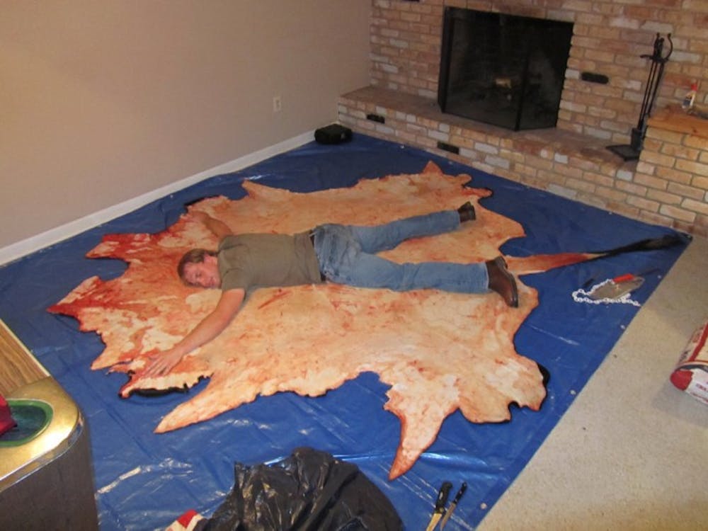 <p>Animal sciences sophomore Matty Love, 19-year-old animal sciences sophomore, stretches out on his proudly purchased cowhide. Love is currently in the process of preserving the cowhide.</p>