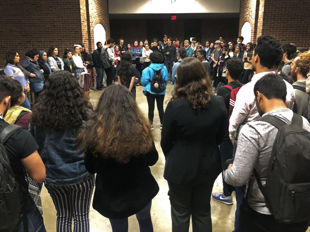 About 100 students hold a candlelight vigil outside of Little Hall Tuesday night. The group walked out of Michanie’s speaking event in protest of the bombings in the Gaza Strip by Israel.&nbsp;